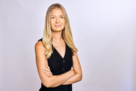 Victoria Ellis of Land & New Homes Network smiling with arms folded, wearing a black waistcoat
